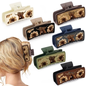 Detail view of rectangular matte hair claws with highland cow and sunflower patterns
