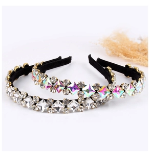 Detail showing luxurious crystal rhinestones on black fabric headband with refined cuts