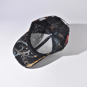 Inside view of black baseball cap with golden baroque prints and plastic liner support