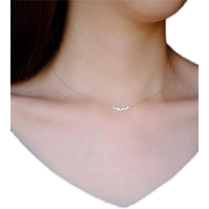 Elegant gold S925 silver smile necklace with sparkling zircons worn by a model