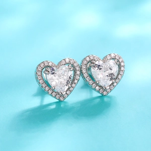 Elegant silver heart stud earrings with sparkling crystals on a Tiffany blue backdrop