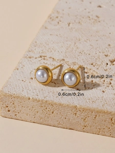 Detailed macro view showing the 0.6cm diameter measurement of white pearl stud earrings