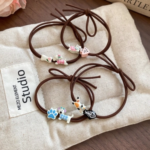Detailed view of elastic hair ties with cute resin cartoon puppy and kitten charms
