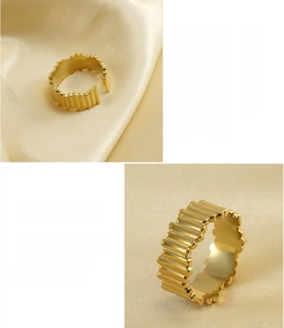 Macro detail of 18K gold plated stainless steel ring with elegant wavy texture