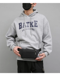 Detail of black heavy-duty waist bag with three zipper compartments for men