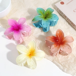 Y2K frangipani flower hair claws in colorful resin set against minimalist background