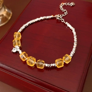Detailed close-up of citrine beads and faceted silver beads on a luxury layered bracelet