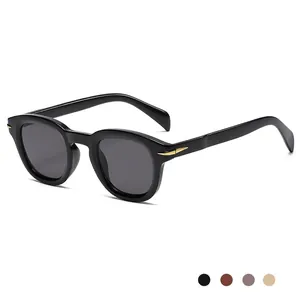 Modern retro round black sunglasses with gold arrow hardware and dark grey lenses
