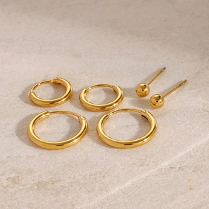 Three-piece gold plated stainless steel set featuring hoop and ball stud earrings