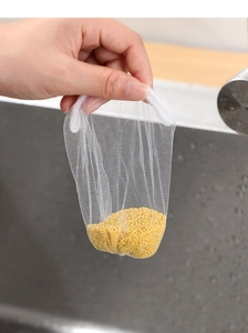 Close-up of fine mesh sink strainer bag filtering food residue in a kitchen sink