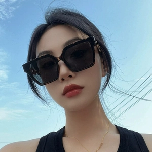 Classic oversized square sunglasses with dark lenses and gold logo detail for women