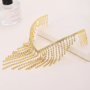 Elegant gold metal hair comb featuring shimmering crystal rhinestone tassels on a beige surface