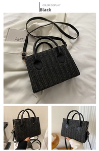 Detail of black woven straw square bag featuring PU handles and golden hardware