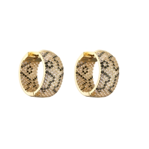 Detail of gold hoop earrings with micro-paved black and clear cubic zirconia leopard pattern