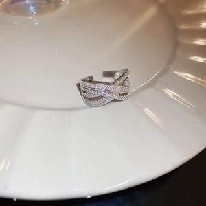 Close-up of silver zircon horse ring with cross-weave design and small crystals