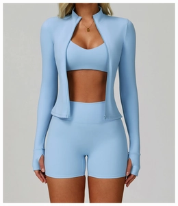 Detail of light blue yoga set featuring thumb holes on sleeves and high waist shorts