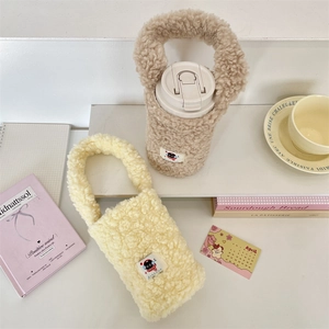 Macro detail of soft fleece water bottle carrier bag with handle and cute woven label
