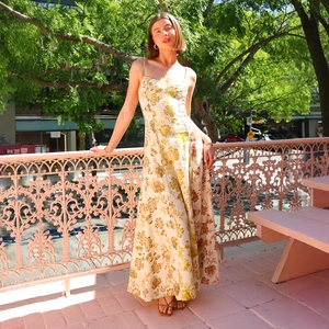Close-up of the elegant floral print and fine spaghetti straps on a summer maxi dress