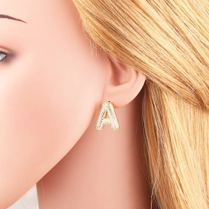 Gold plated letter A stud earring with white cubic zirconia worn by model