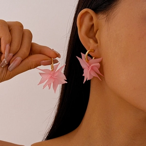 Pink matte acrylic flower petal C-shaped earrings with gold ring buckle on model