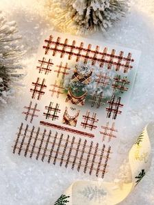 Macro view of Christmas plaid nail stickers with red, brown and gold relief pattern