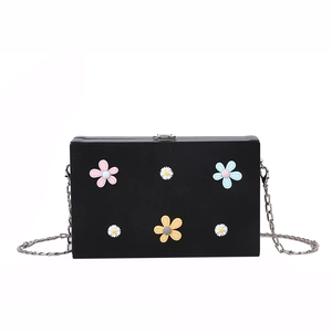 Chic black square bag with colorful 3D flowers and a silver metal chain strap