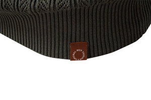 Detail of dark olive knit sweater hem with ribbed cuff and original men fashion leather patch