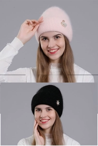 Detail of pink and black knit beanies with faux rabbit fur texture and swan brooch