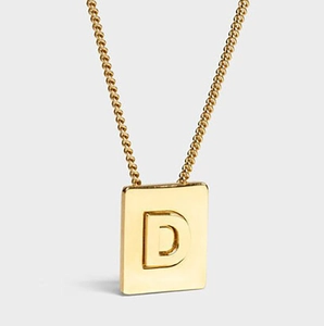 Detail of 18K gold stainless steel necklace with a 3D embossed letter D rectangular pendant