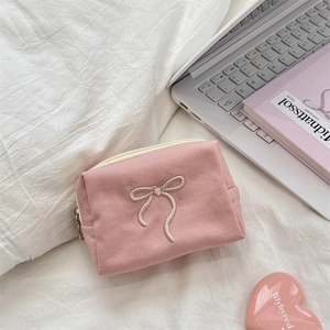 Pink canvas small pouch with bow embroidery, zipper closure and soft aesthetic layout