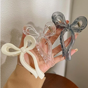 Three elegant jelly-textured bow hair claws in cream, clear, and grey for women