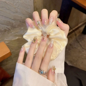 Handmade press-on nails with 3D gold bows, pearls, and hand-painted roses in a French style