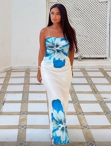 Detailed view of white strapless maxi dress featuring vibrant blue floral print patterns