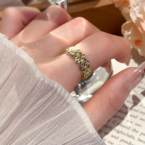Close-up of vintage 18k gold plated open ring with colorful stones and lace cuff details