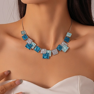 Close-up of geometric square enamel pendant necklace set in blue and silver gradients