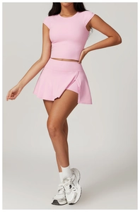 Close-up of pink high-elastic athletic skort and cropped top on a fitness model