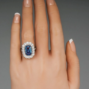 Luxury ring featuring cushion-cut blue zircon with double-layer halo on model hand