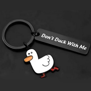 Detail view of cartoon duck keychain with a black tag saying Don't Duck With Me