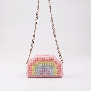 Pink handmade pearl crossbody bag with colorful rainbow pattern and gold metal chain