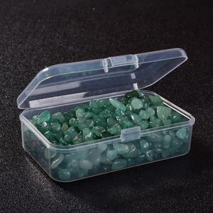 Detail view of green irregular gemstone chips stored in a clear plastic organizer box