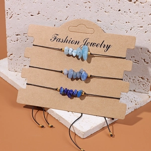 Detailed view of three blue natural crystal stone bracelets with adjustable black cords