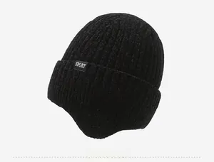 Detailed side view of black chenille knit ear flap hat with SPORT label for winter