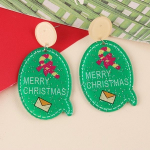 Macro detail of acrylic Christmas earrings with candy cane pattern and Merry Christmas text