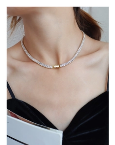 Close-up of elegant gold choker necklace featuring baguette-cut sparkling zircon stones
