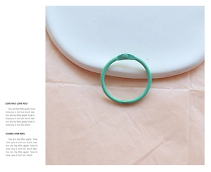Detailed view of a mint green metal hinged ring binder with a matte paint finish