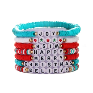 Detail of Christmas clay bead bracelets with JOY and MERRY letter charms and festive colors