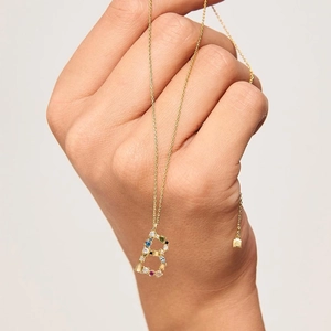 Macro detail of gold S925 silver letter B pendant with colorful zircon stones