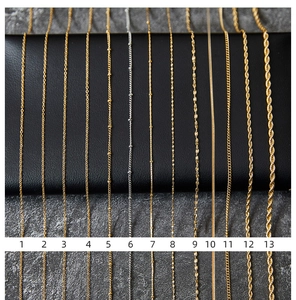 Thirteen varieties of gold and silver plated stainless steel chains displayed with labels