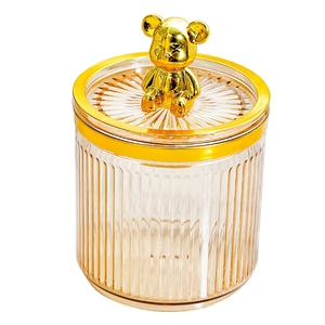 Vertical striped food storage jar with golden bear lid in high angle view