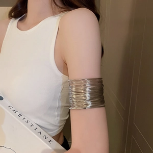 Close-up of a silver multi-layer wire upper arm cuff bracelet on a model's arm